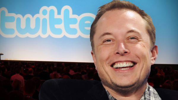 Elon MUsk in front of a screen that says Twitter