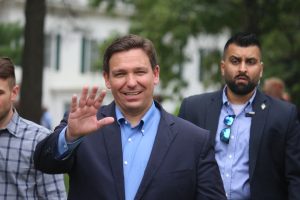 Ron DeSantis outside with two men