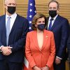 Pelosi surrounded by men in suits all wearing face masks