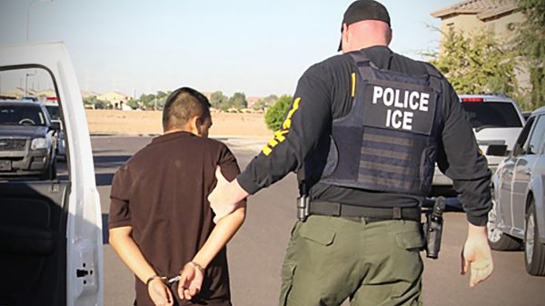 Man being arrested by ICE agent in 2011
