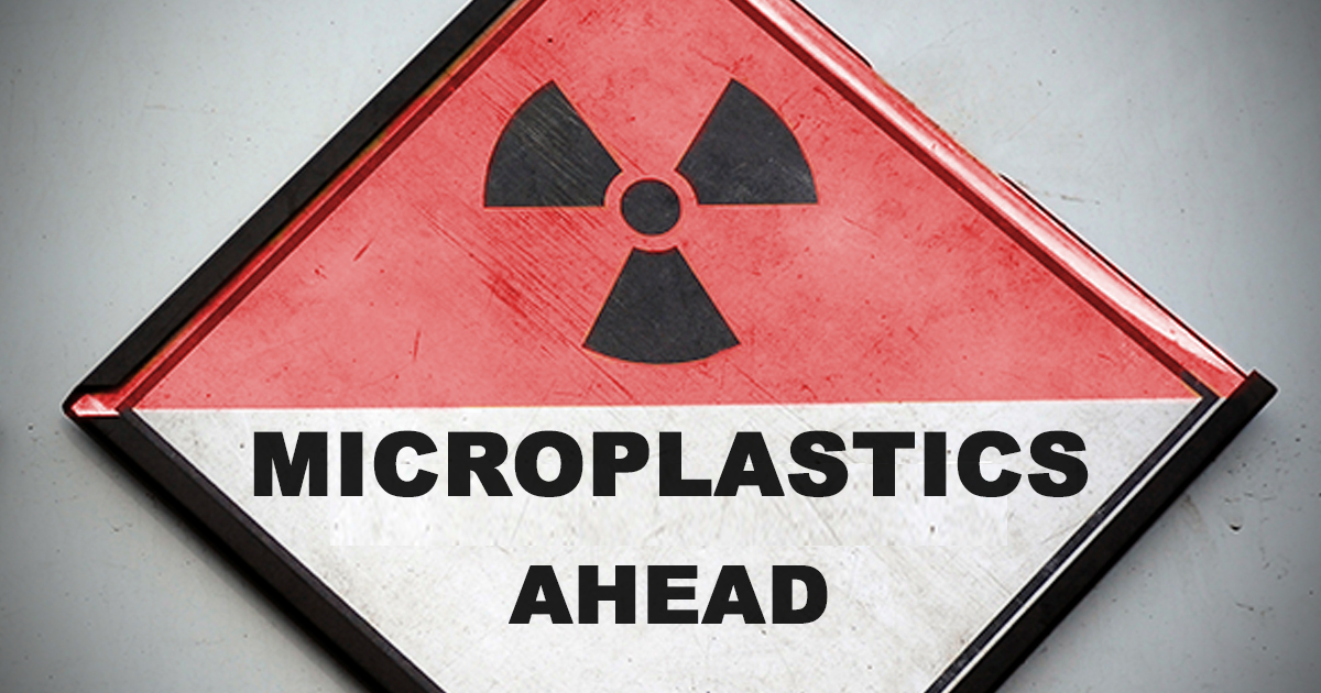 Sign with radioactive symbol that says 'Microplastics ahead'