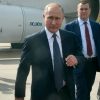 Vladimir Putin and associates depart a plane