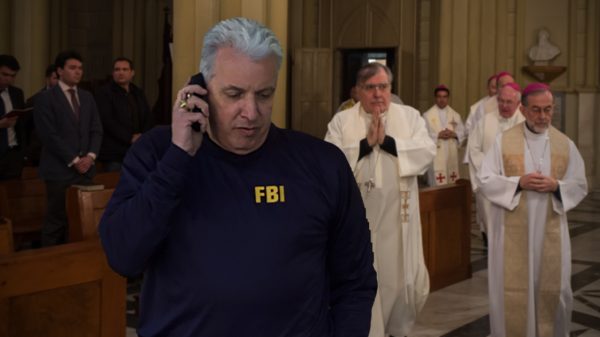 FBI agent superimposed in a Latin Mass service
