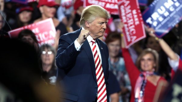 Trump raises his fist on stage in Arizona