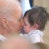 Biden sniffing an infant