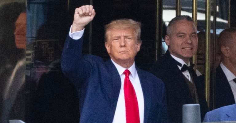 Trump with his fist raised outside Trump Tower