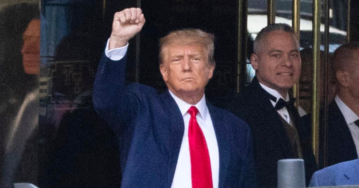 Trump with his fist raised outside Trump Tower