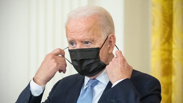 Joe Biden taking off a face mask