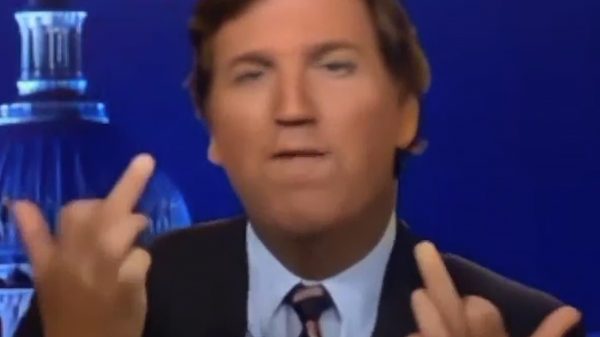 Tucker Carlson raising two middle fingers