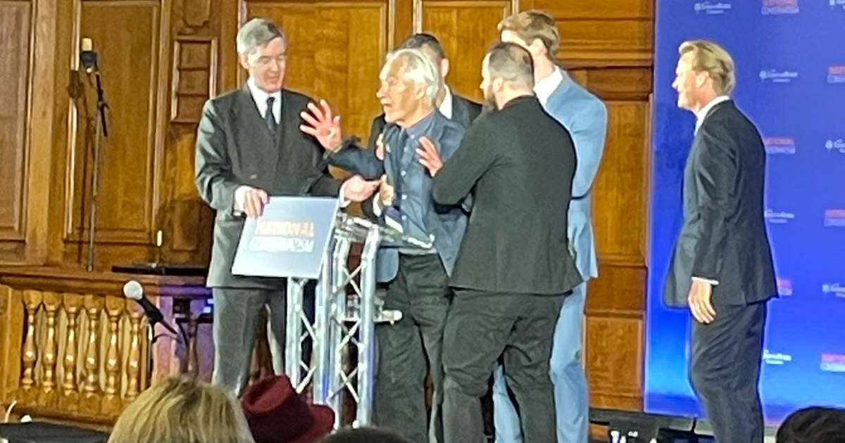 Men surround the protester to remove him