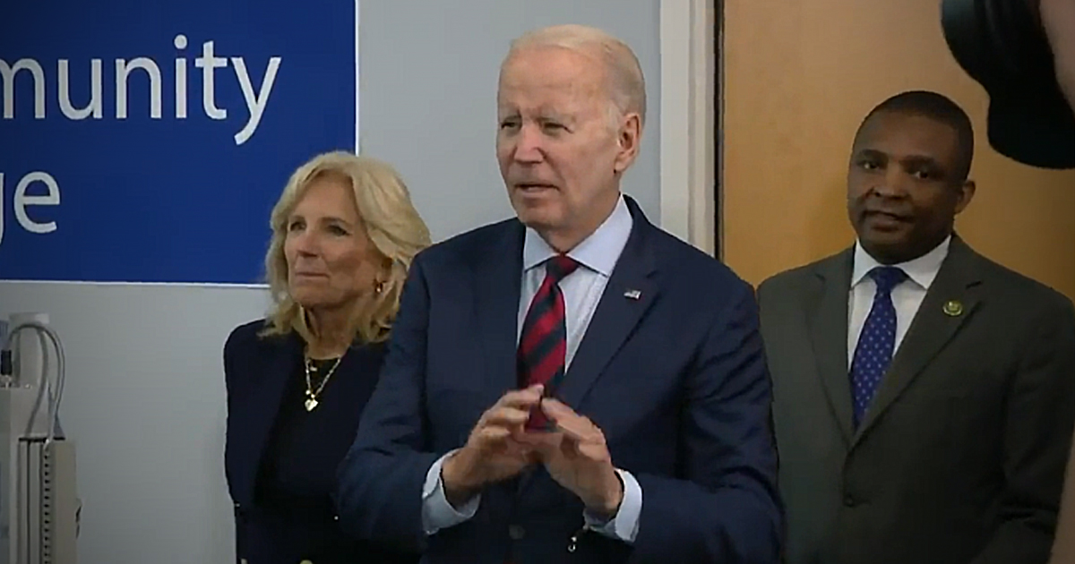 Joe Biden and Jill Biden standing in a community college