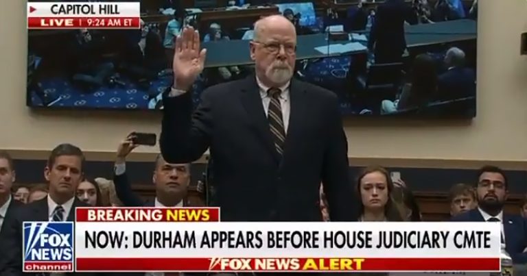 John Durham raising his hand to swear in