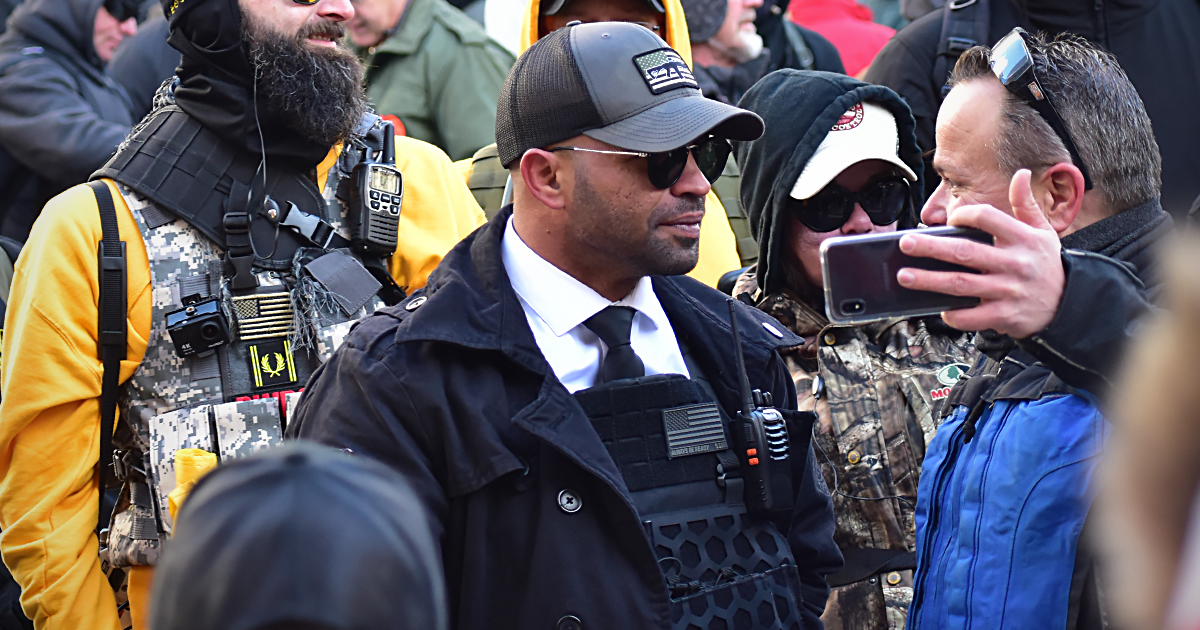 Enrique Tarrio surrounded by people at a rally in 2020