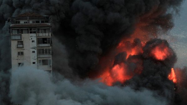 Explosions and fire envelop a building in Gaza