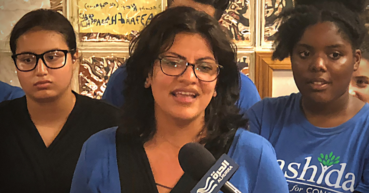 Rashida Tlaib stands with supporters