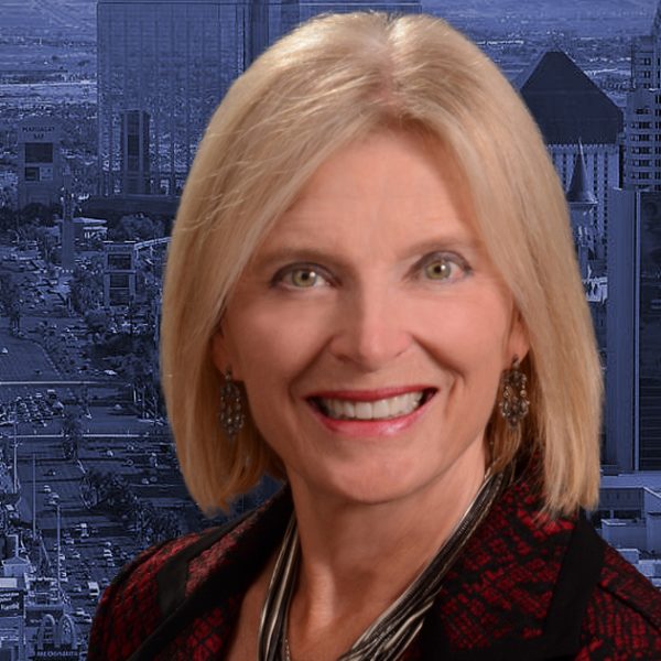 Headshot of Heidi Kasama with Las Vegas skyline in the background
